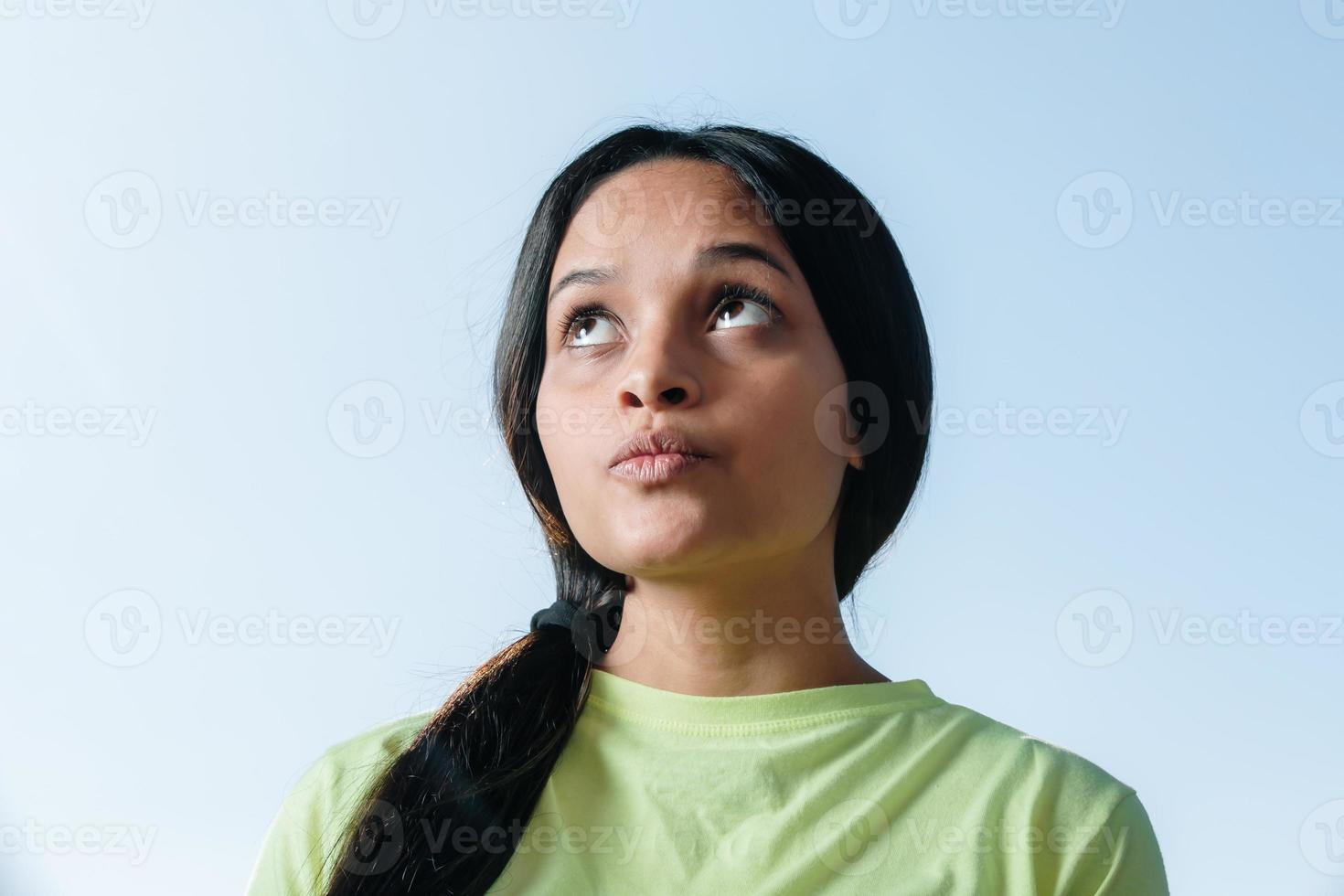 Young brunette student thinking. photo