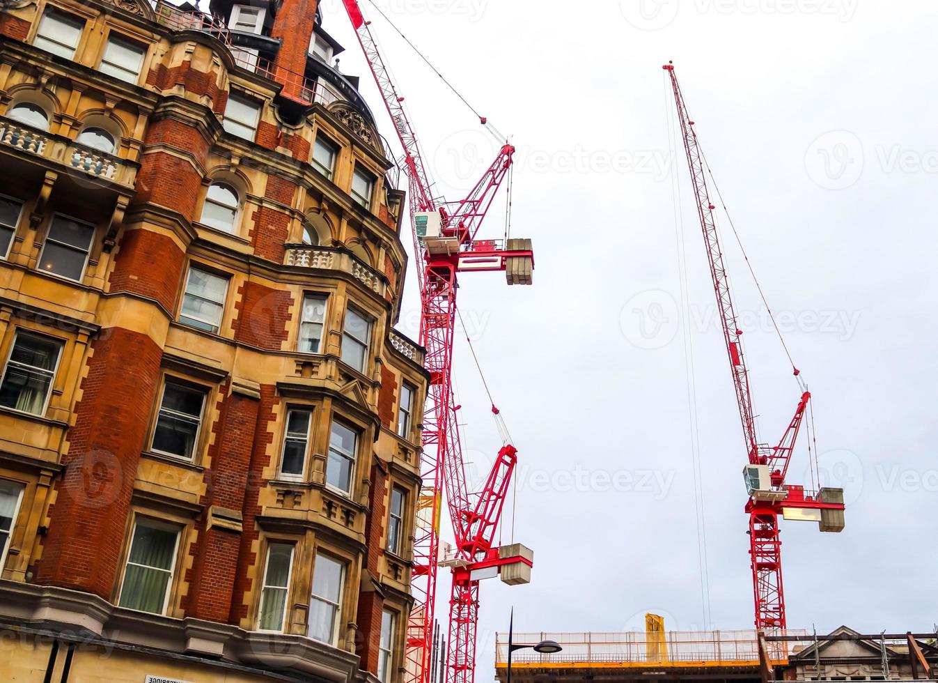 Several cranes on constructions sites at high buildings all over Europe photo