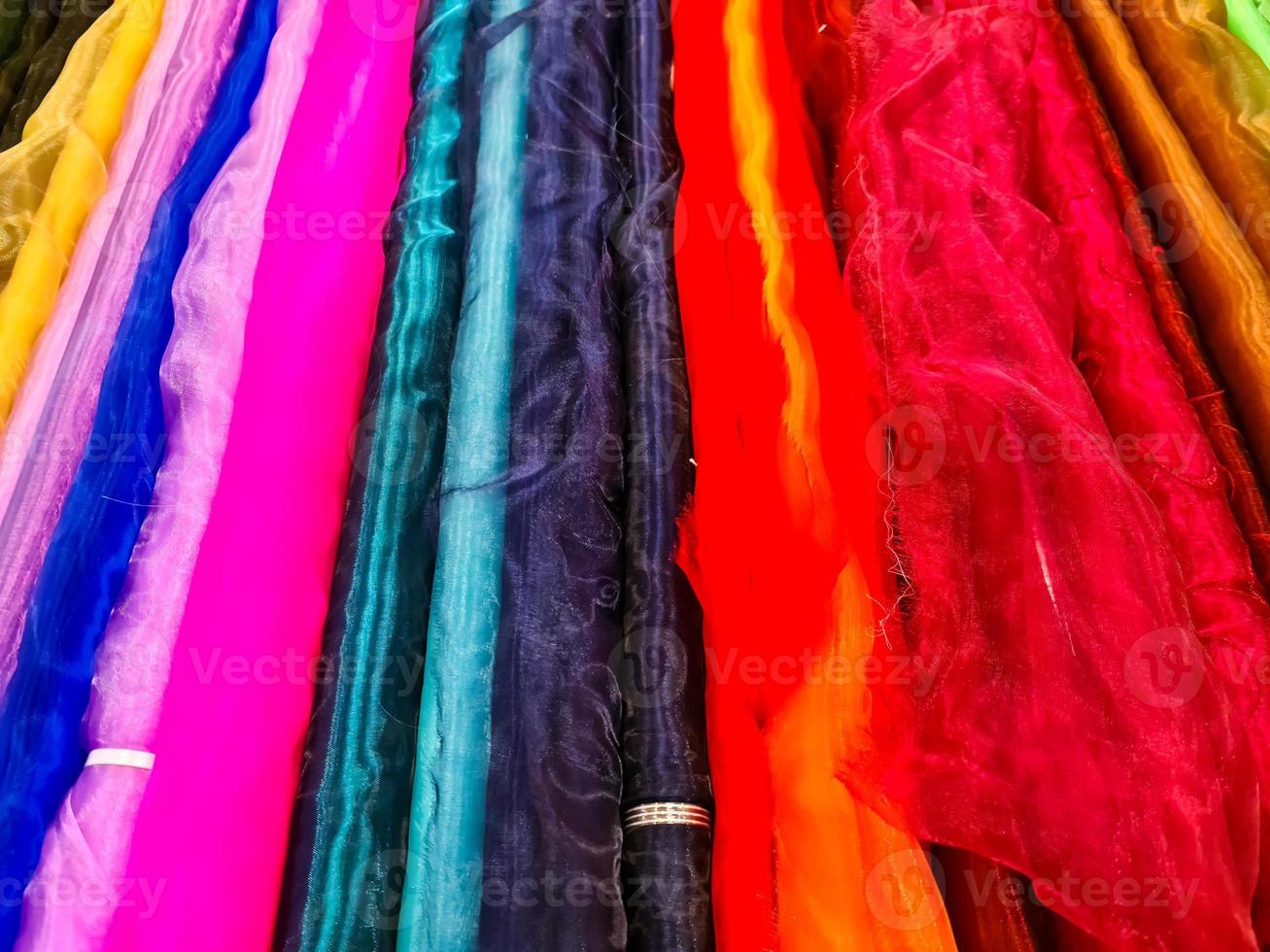 Samples of cloth and fabrics in different colors found at a fabrics market. photo