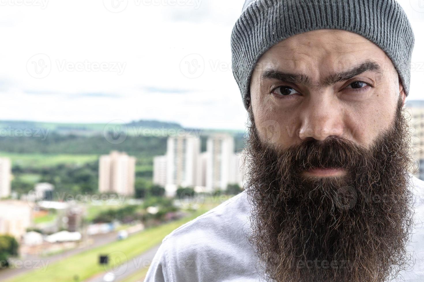 Bearded man looking the horizon. Concept of masculinity and care with the beard. photo