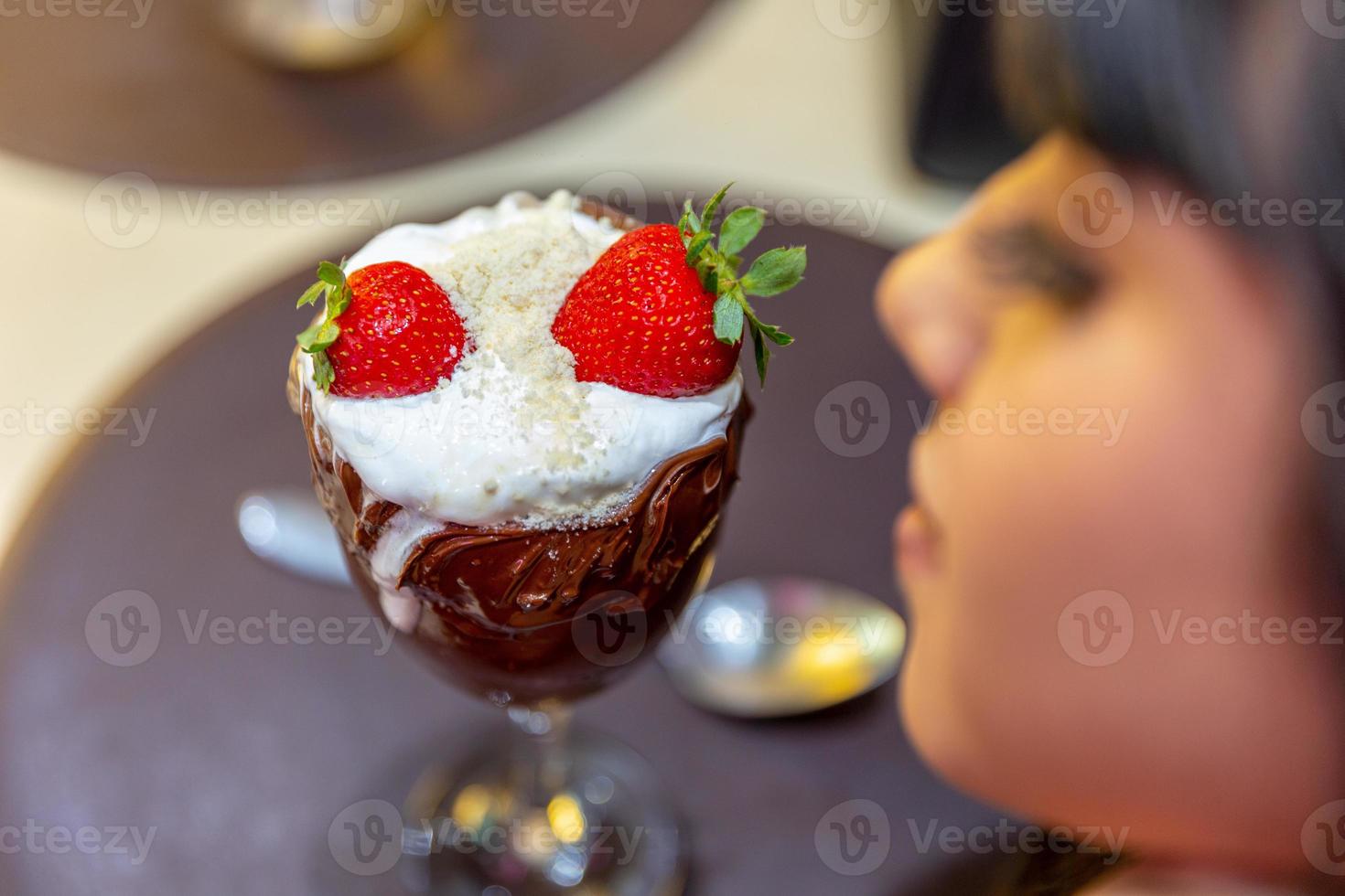 Ice cream white blends strawberry with high calories, can make you fat, soft focus, blurred. Delicious vanilla or chocolate sundae with strawberry. photo