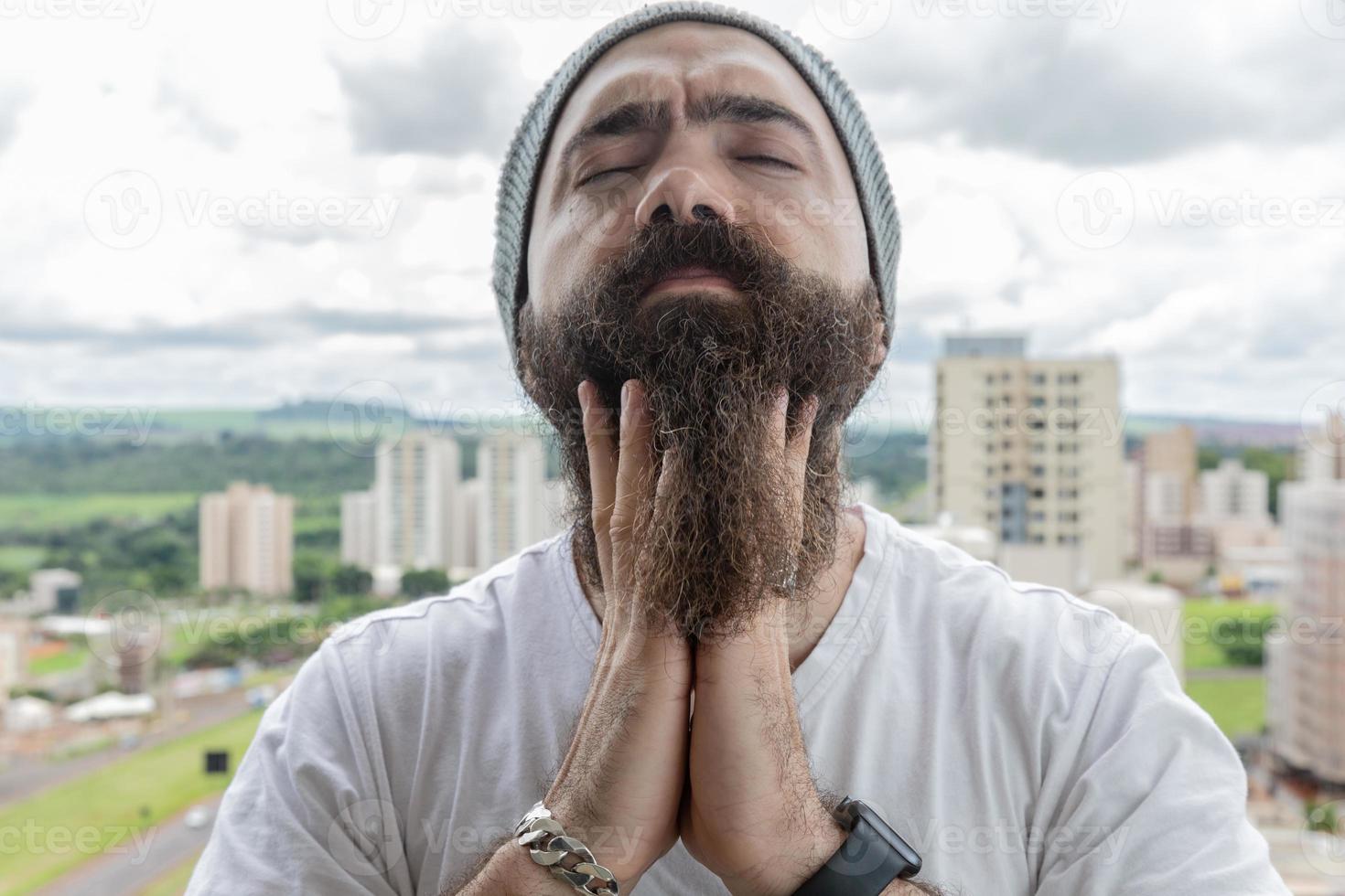 Bearded man with a headache and a lot of worry photo