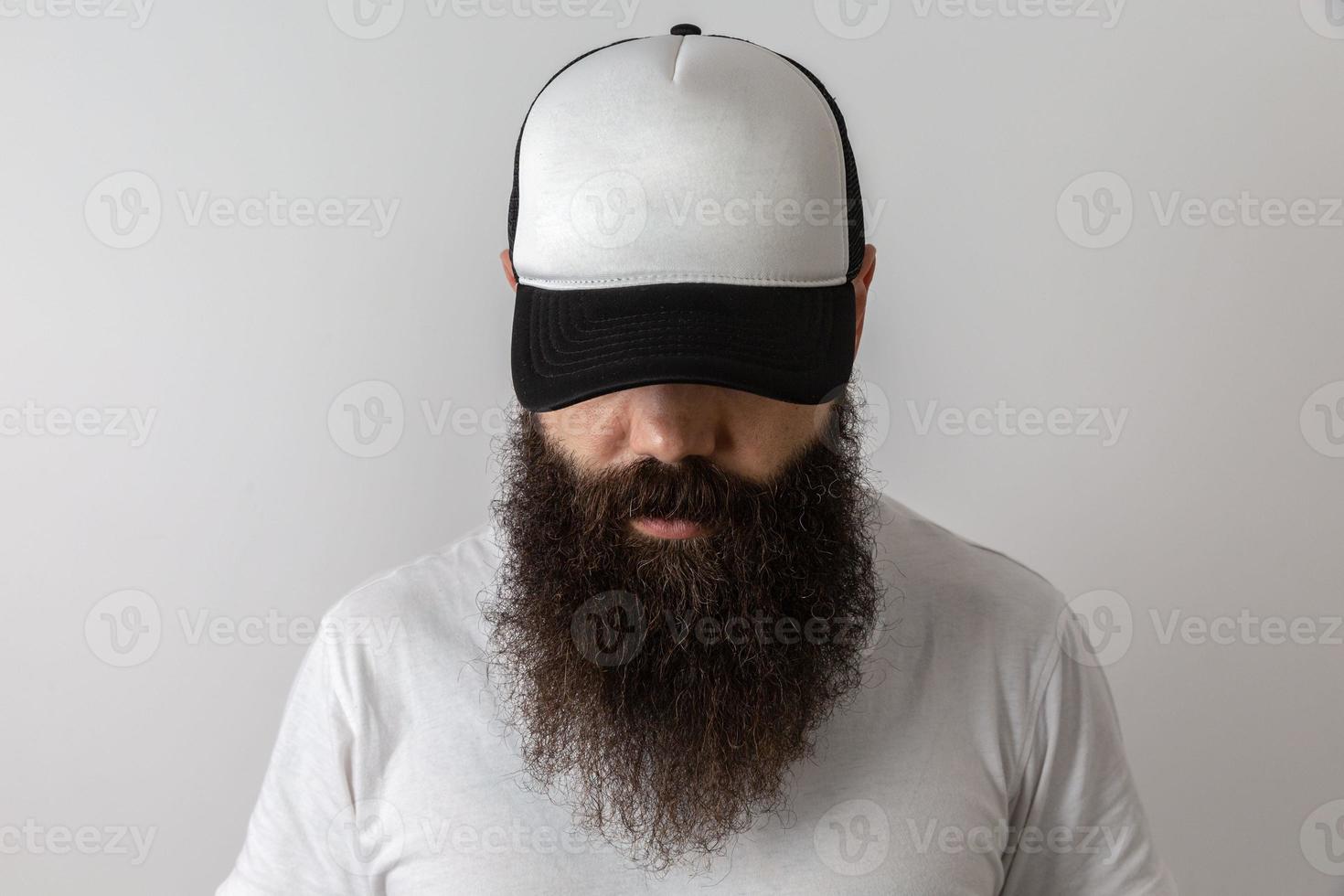 Hipster handsome male model with beard. Baseball cap with space for your logo photo