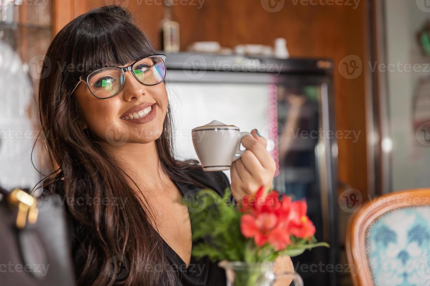 Woman drinking coffee table. Women in cafe. photo