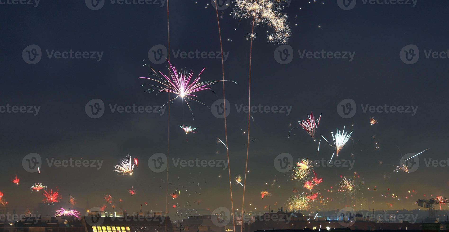 Long time exposure of fireworks over the roofs of vienna photo