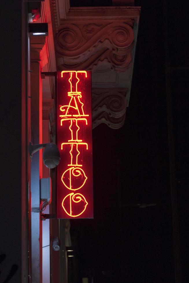 Paris, France - May 01 2019 - Red tattoo neon light sign photo