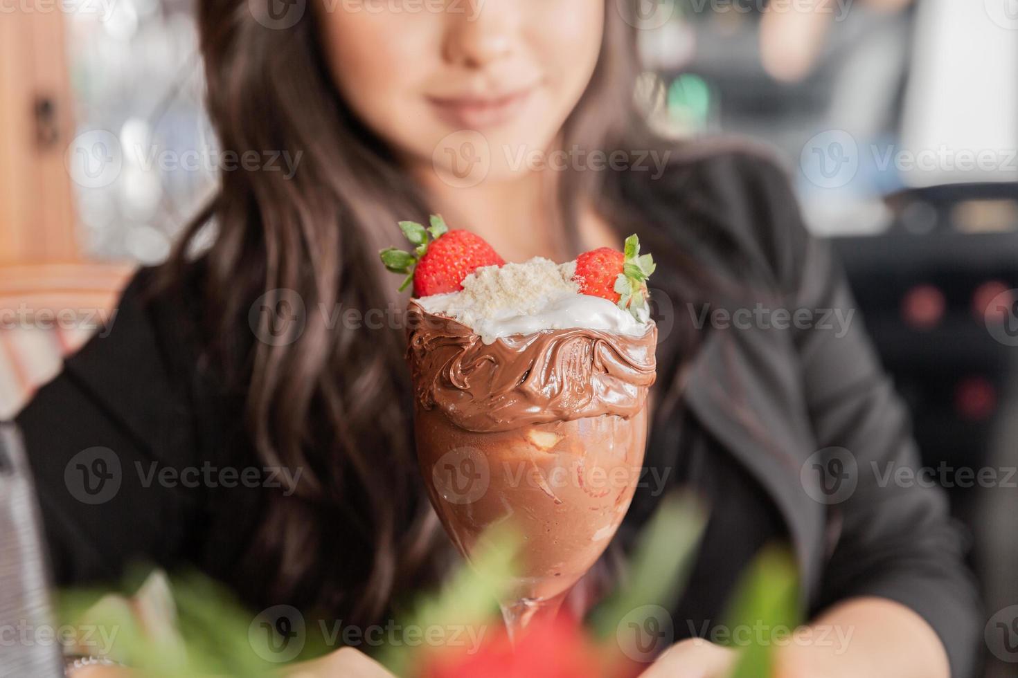 Ice cream white blends strawberry with high calories, can make you fat, soft focus, blurred. Delicious vanilla or chocolate sundae with strawberry. photo