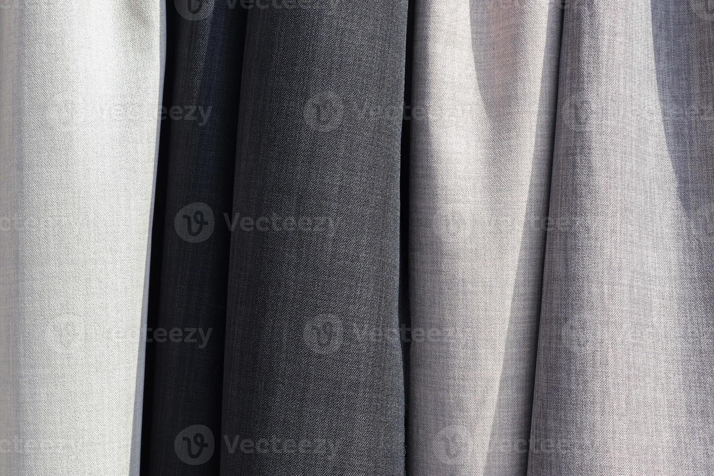Samples of cloth and fabrics in different colors found at a fabrics market. photo