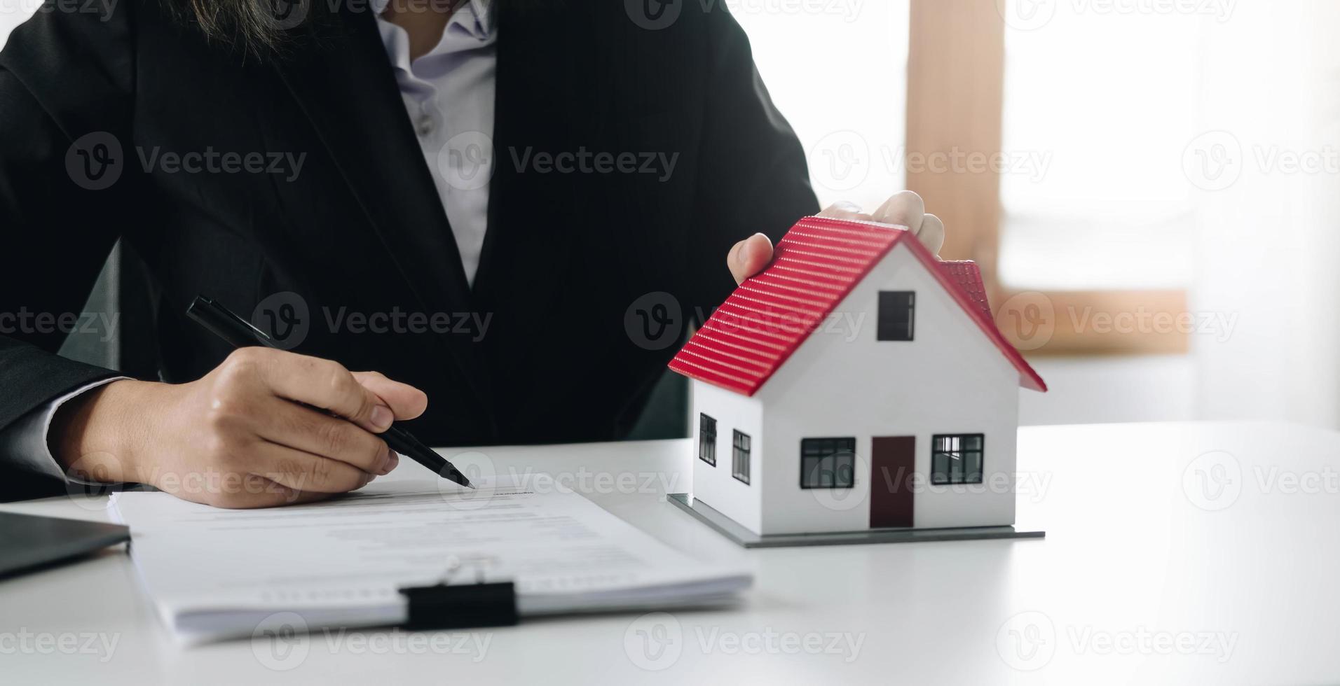 Female woman hands holding home model, small miniature white toy house. Mortgage property insurance dream moving home and real estate concept photo