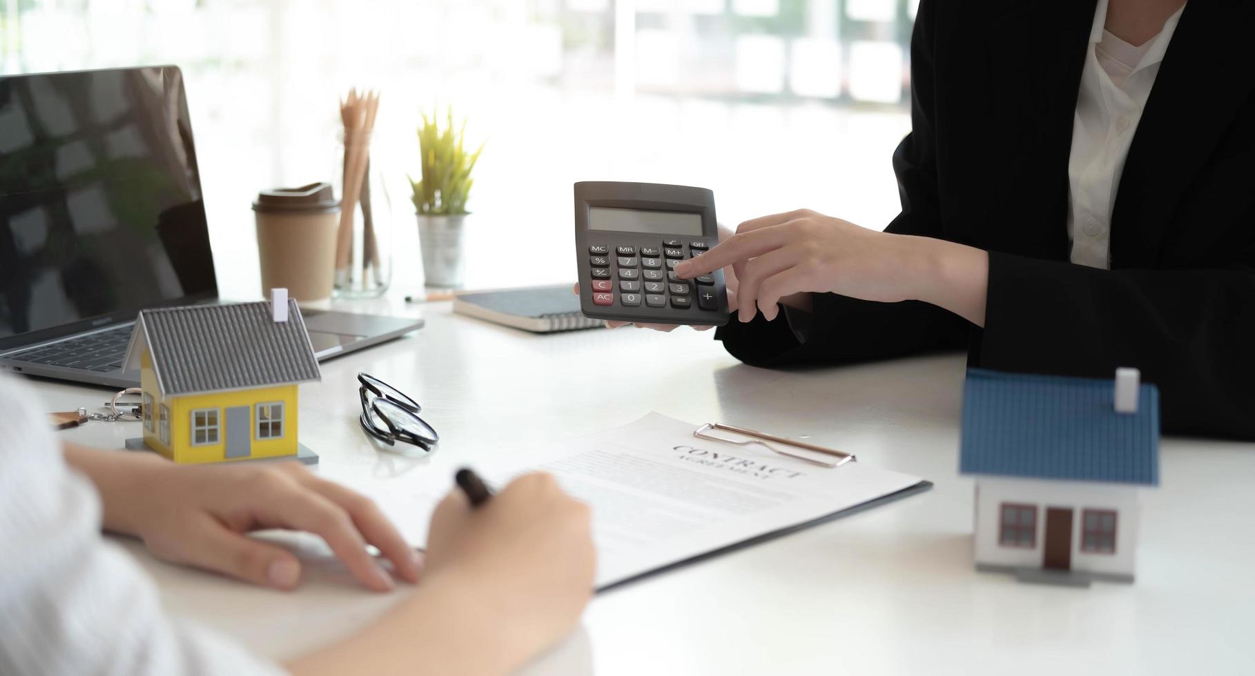 Real Estate Agent broker or House developer showing contract for buying house agreement to consultant employee photo