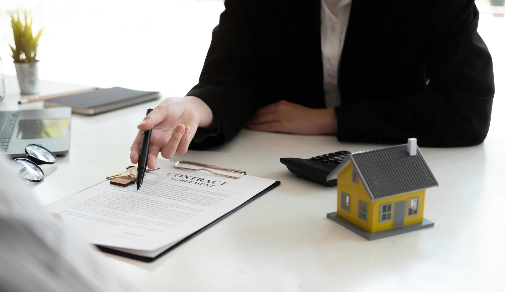 Home agents are explain to customers signing a contract to buy a new home. photo