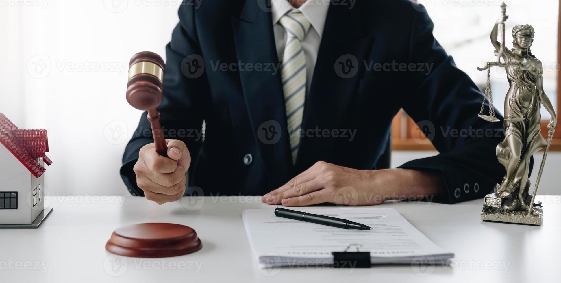 Lawyer or judge holding Hammer prepares to judge the case with justice, and litigation, scales of justice, law hammer, Legal consulting services, Concept of litigation, and legal services. photo