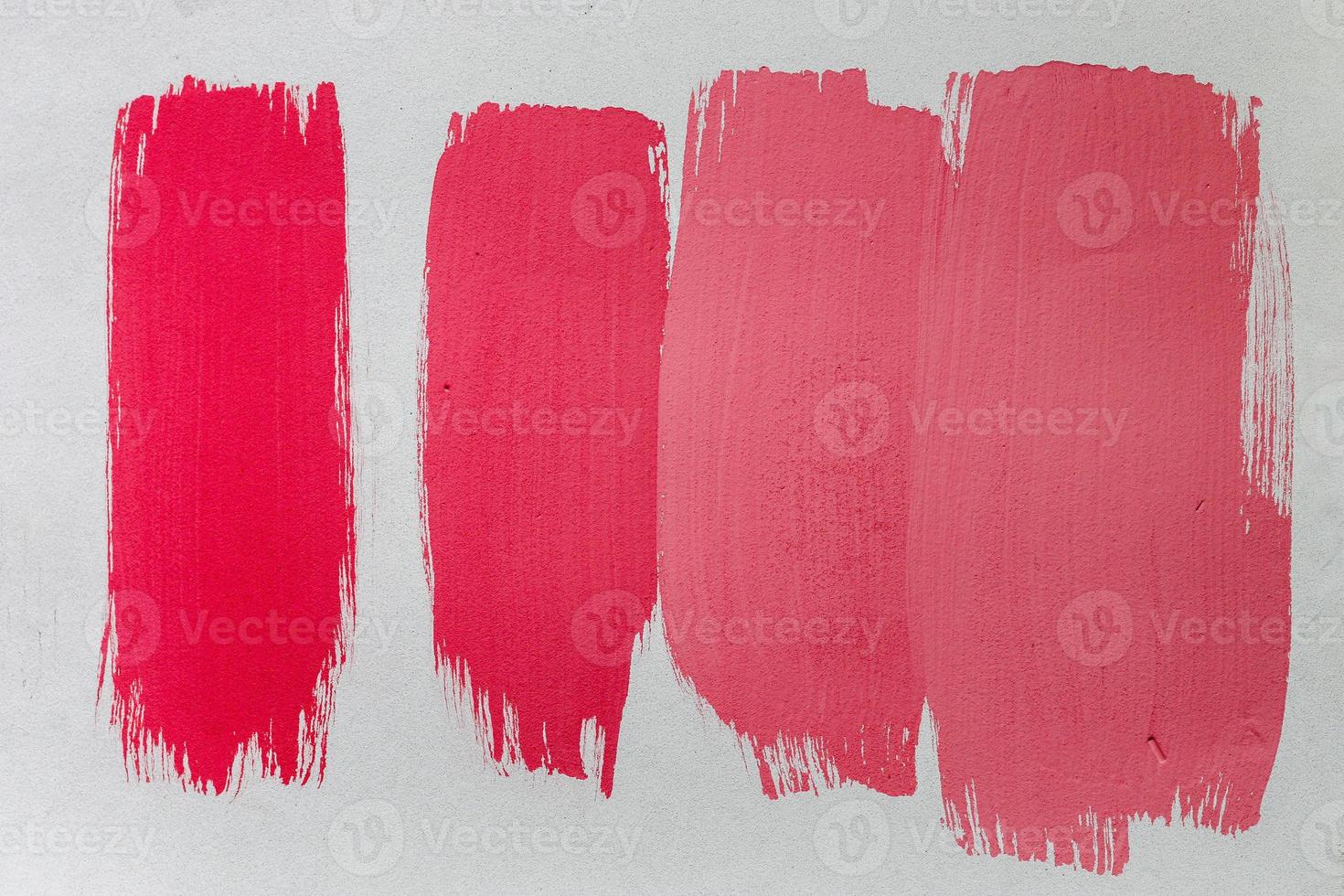 Concept of a paintbrush on a piece of paper with brush strokes in red and brown photo