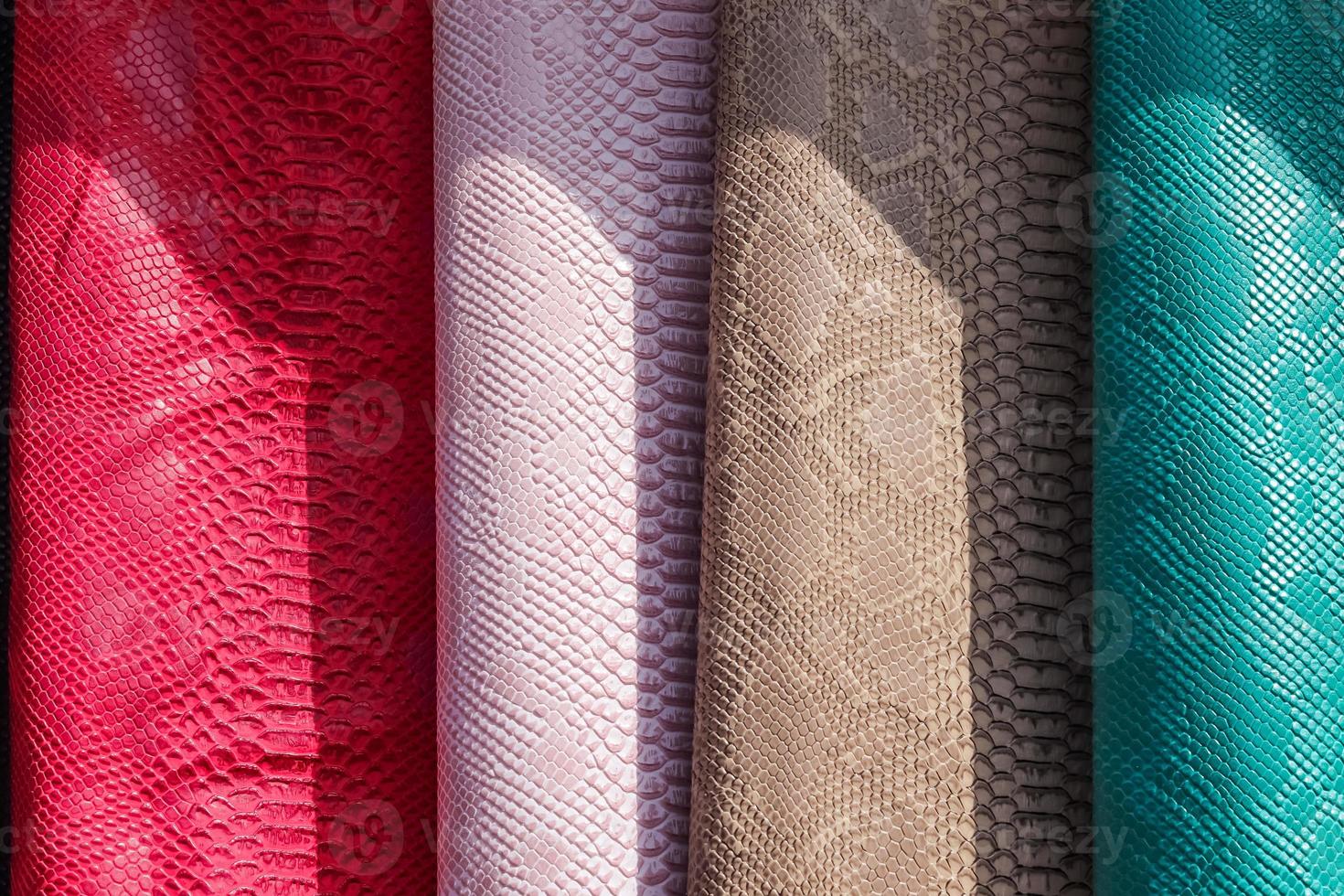Samples of cloth and fabrics in different colors found at a fabrics market. photo