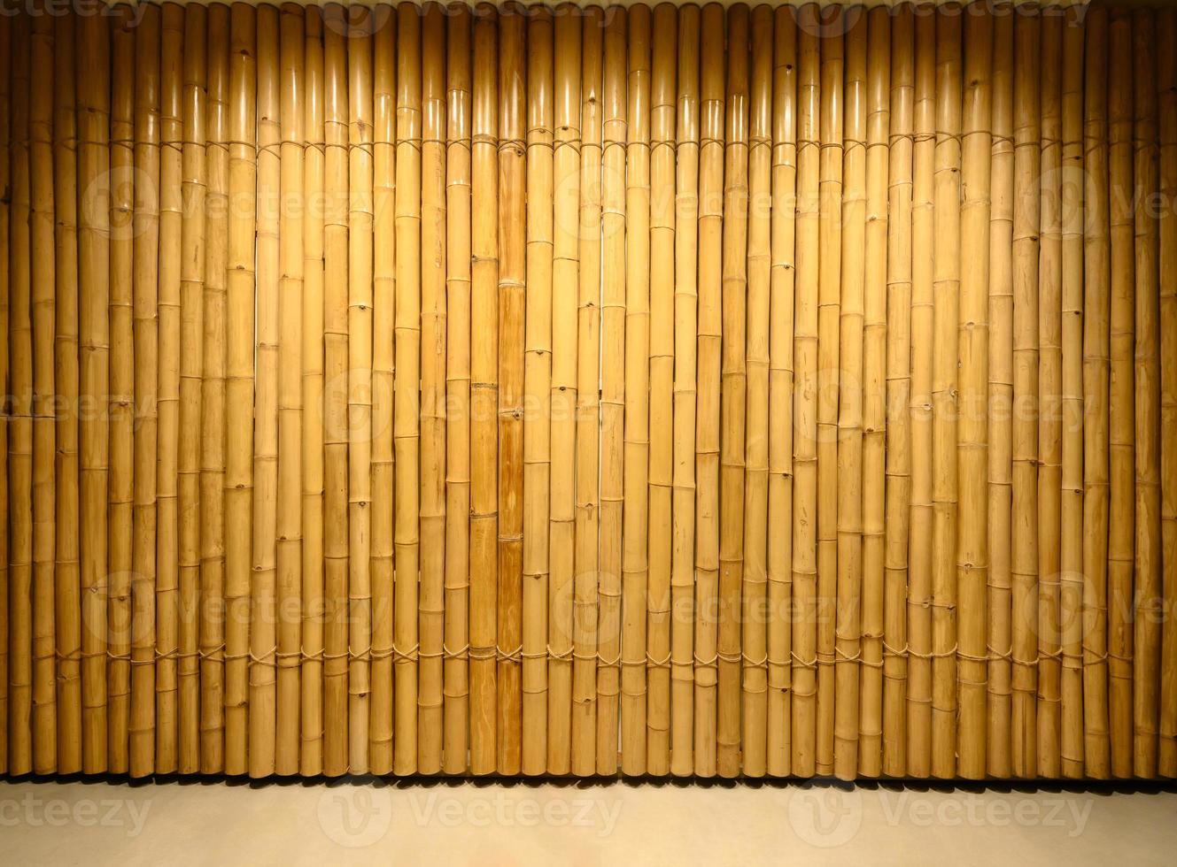 background and texture of decorative yellow bamboo wood on finishing wall surface. photo