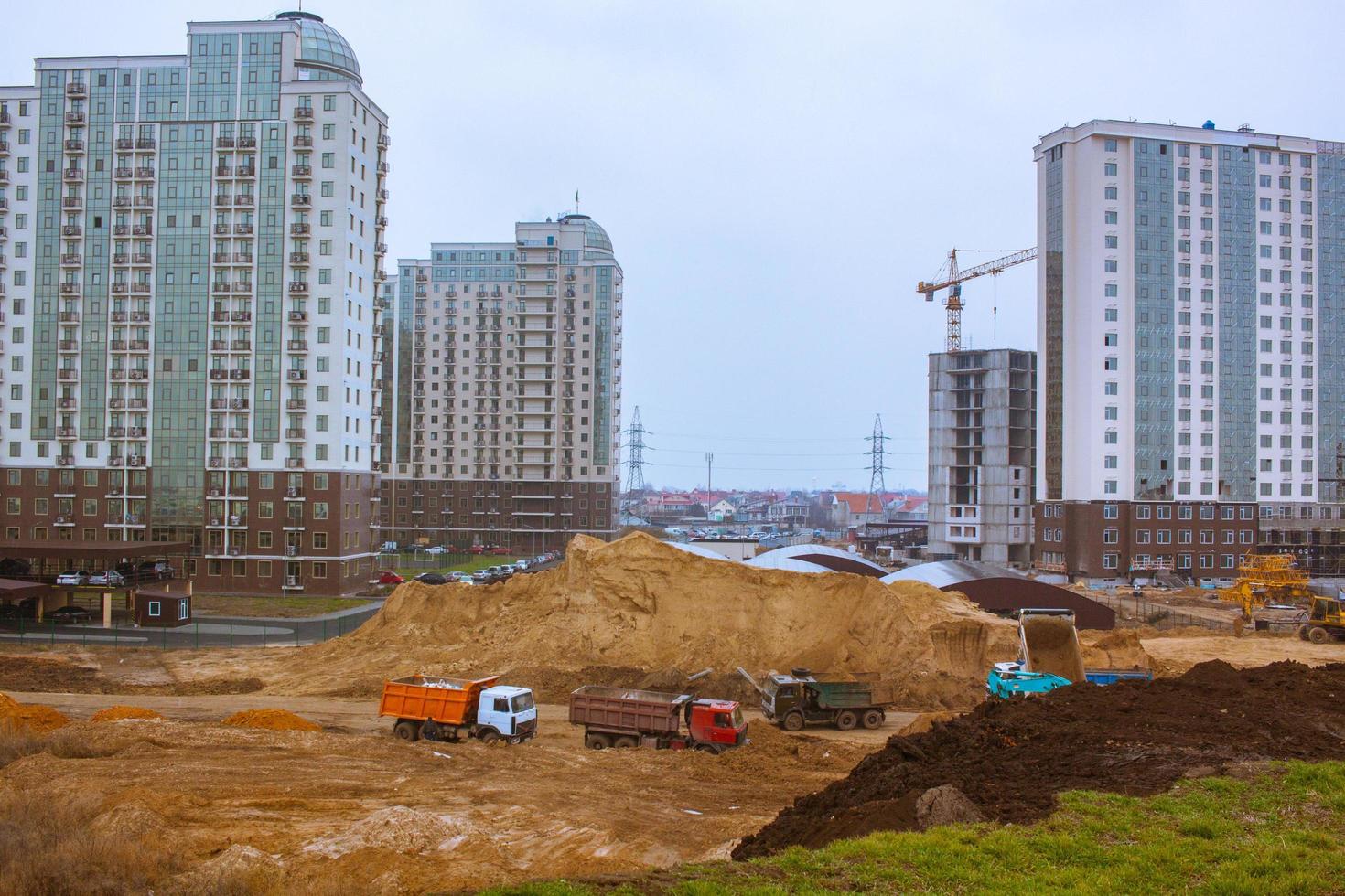 Concrete building in progress with cranes photo