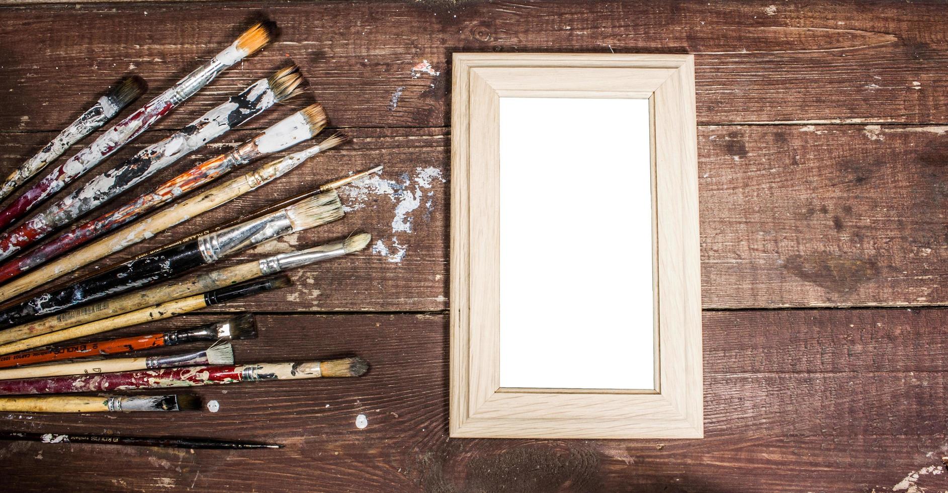 Blank photo frame with paint brushes decoration