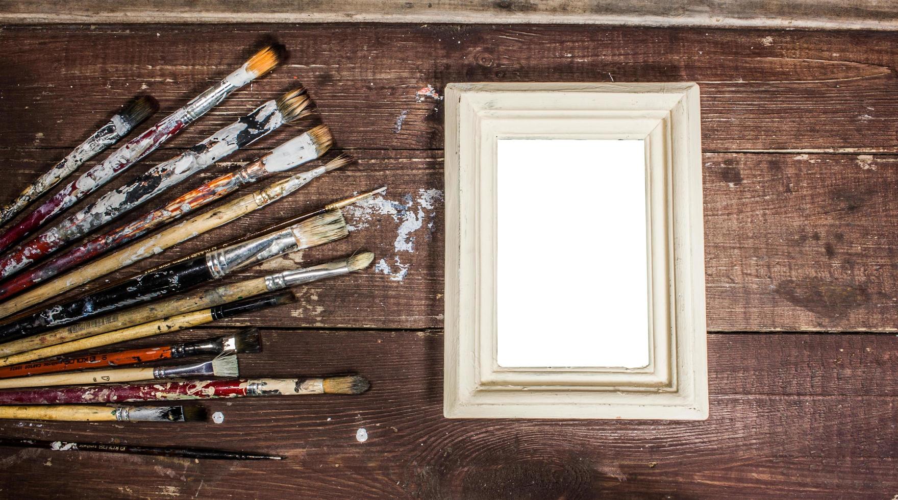 Blank photo frame with paint brushes decoration