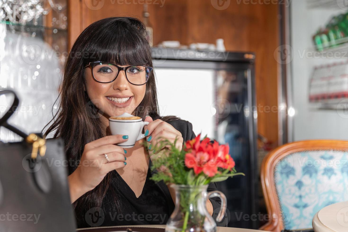 Woman drinking coffee table. Women in cafe. photo