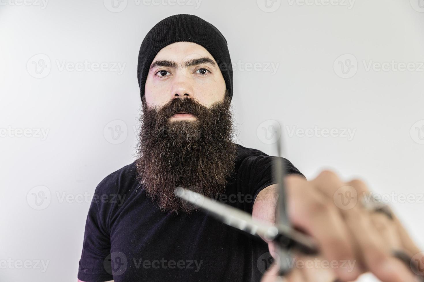 barber with long beard using scissors photo