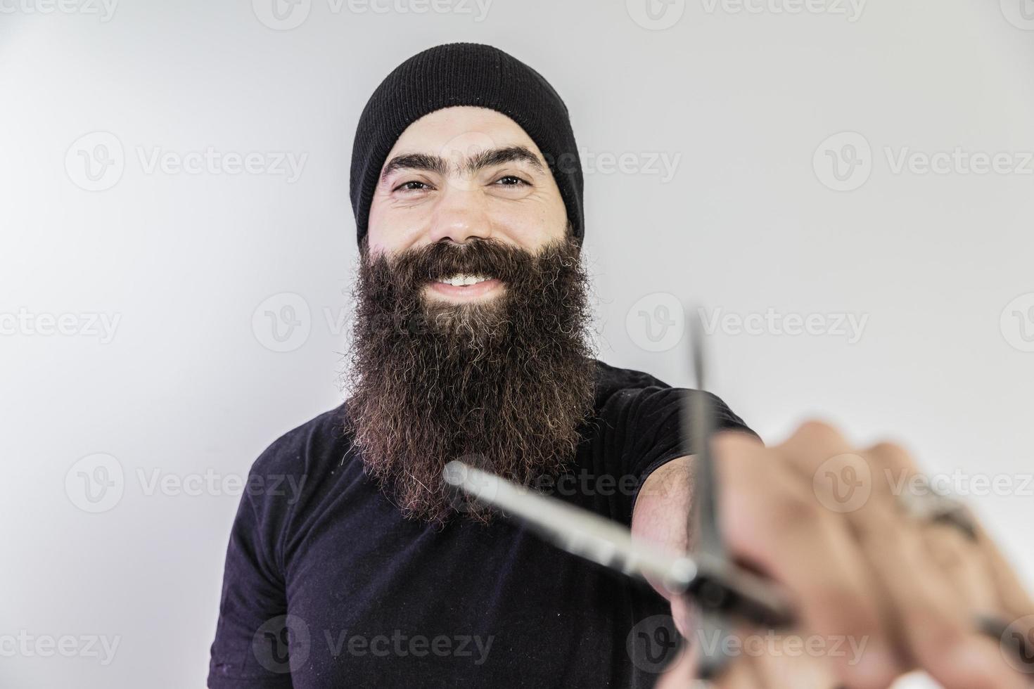 barber with long beard using scissors photo