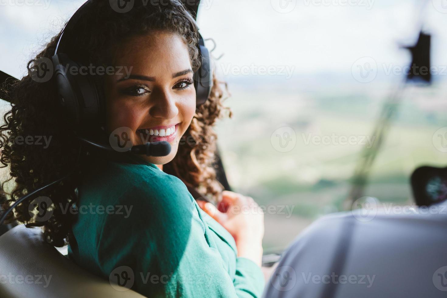 Successful smart stylish young latin woman in the helicopter. Luxury lifestyle concept photo