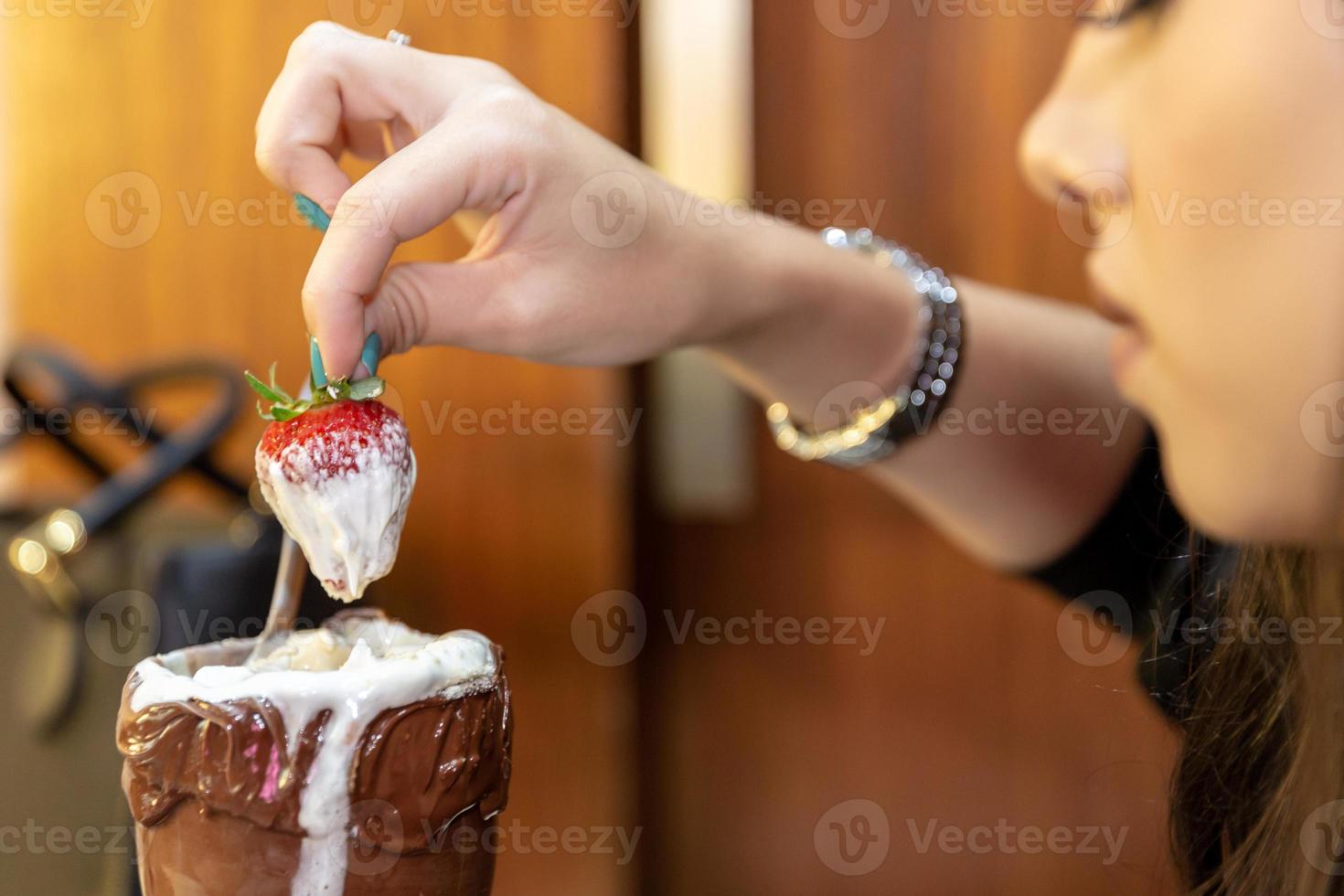 Ice cream white blends strawberry with high calories, can make you fat, soft focus, blurred. Delicious vanilla or chocolate sundae with strawberry. photo