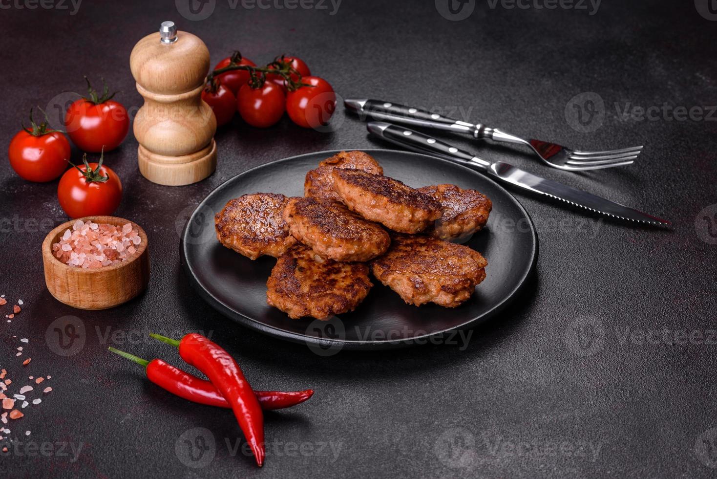 Fish cakes. Fish patties. Fried cutlets of minced fish on a black plate photo