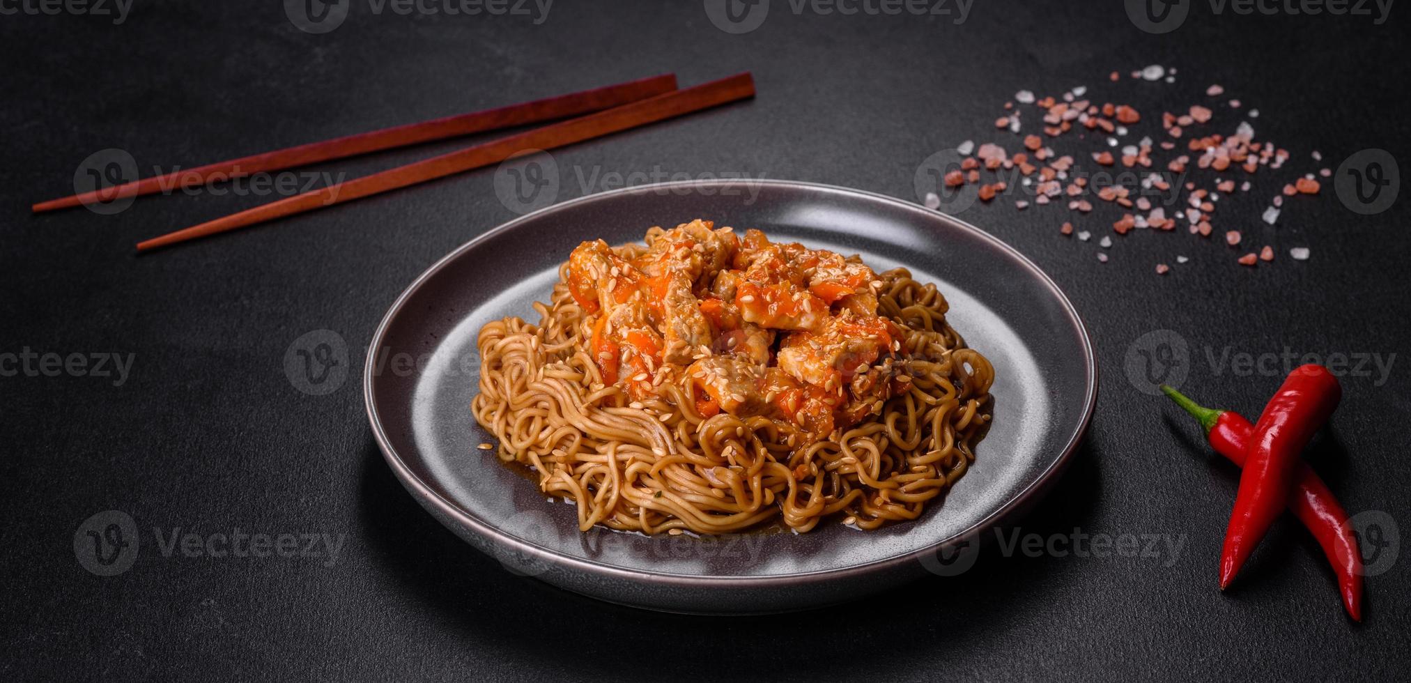 Thai noodle and chicken plate on a black concrete background with Chinese chopsticks and copy space photo