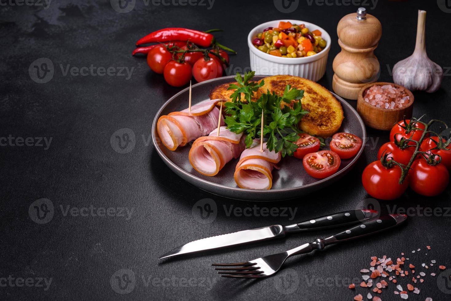 Slices of delicious raw or salted bacon with spices, salt, vegetables and herbs on a wooden cutting board photo