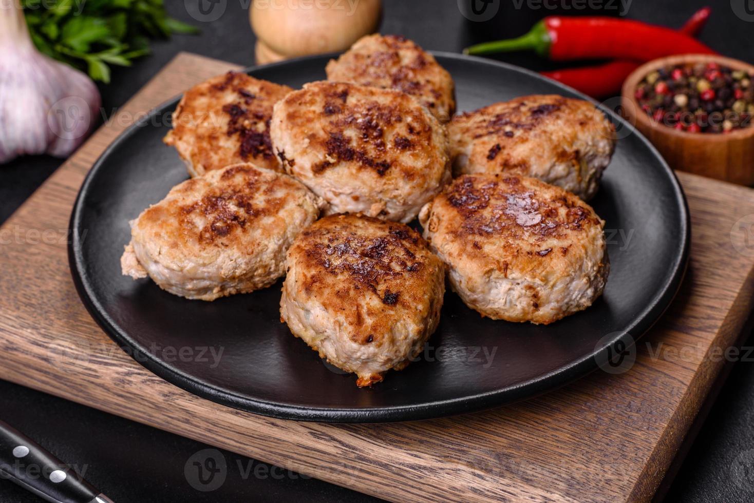 Delicious fresh fried minced meat patties on a dark concrete background photo