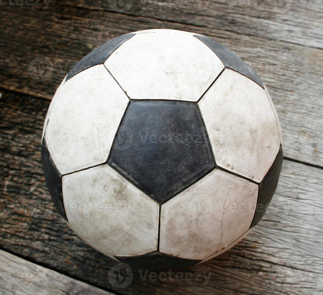 Old Soccer football on old vintage wood table photo