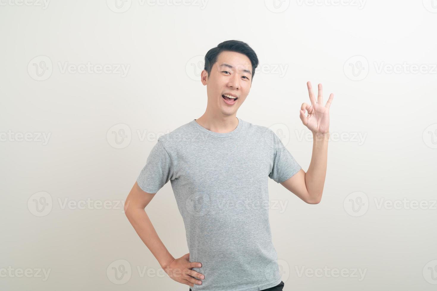 young Asian man thumbs up or ok hand sign photo