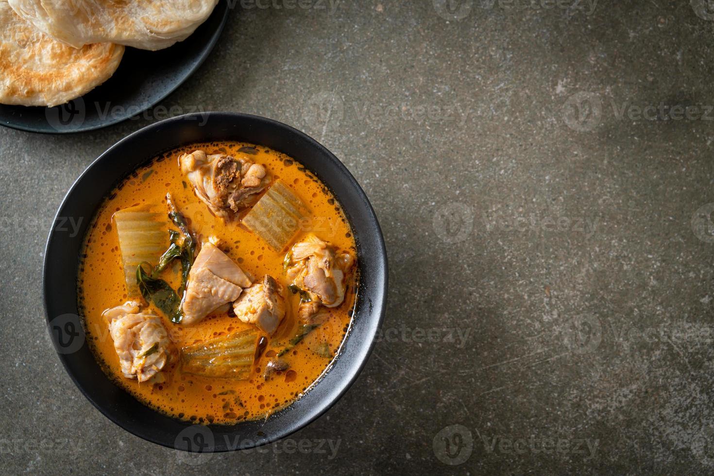 Chicken curry soup with roti photo