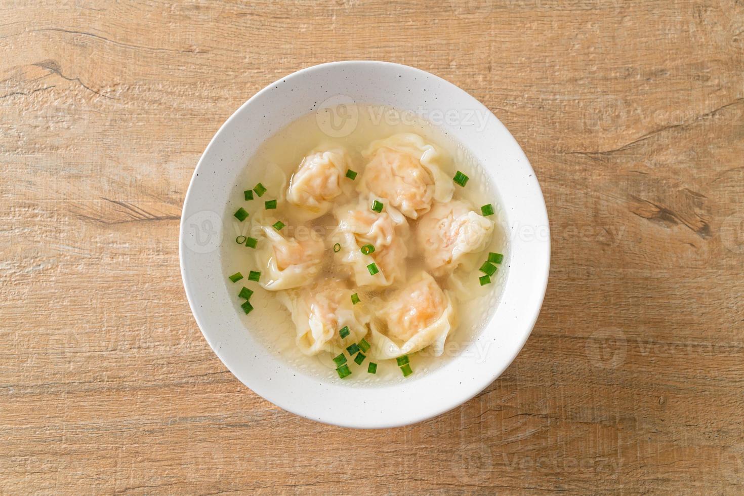 shrimp dumpling soup in white bowl photo
