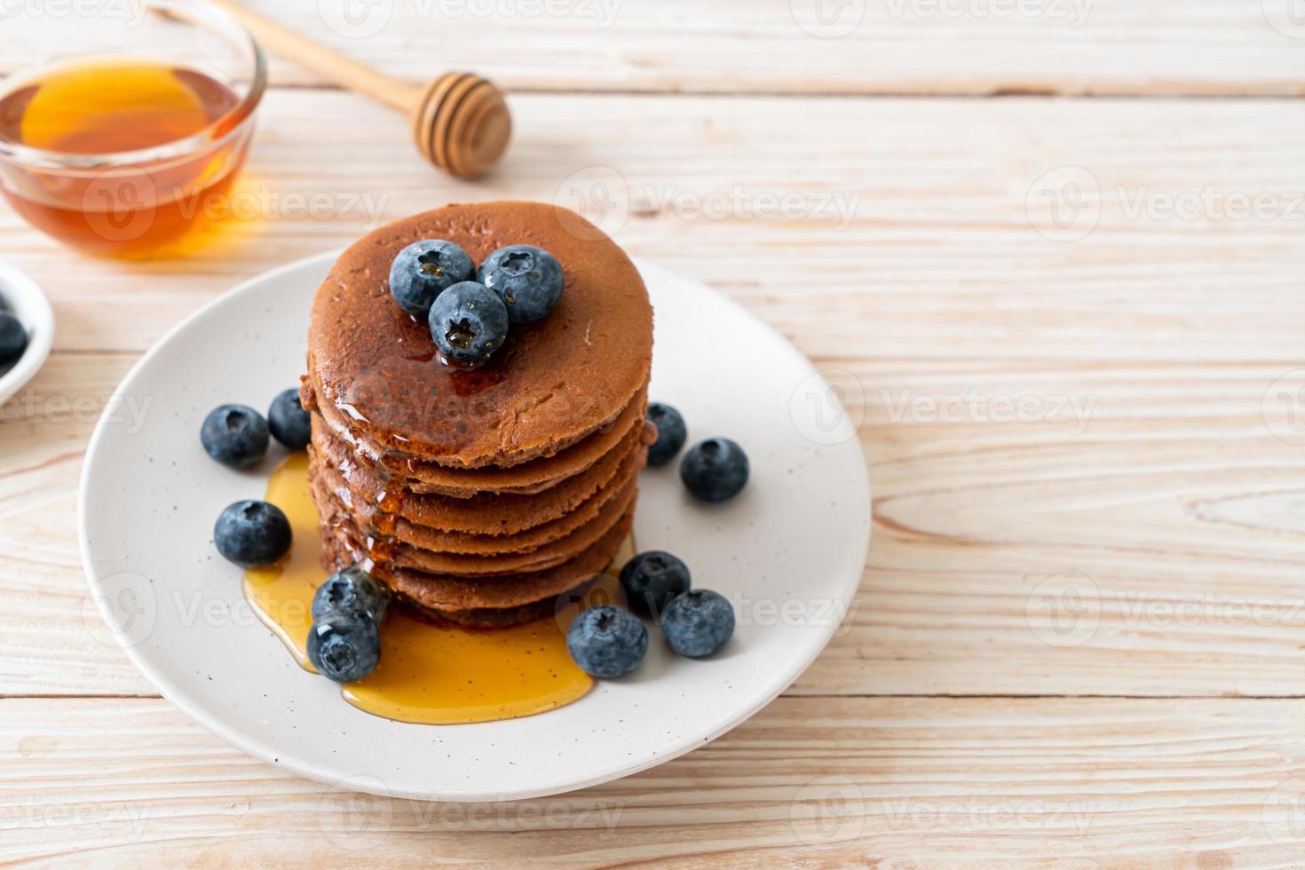 chocolate pancake stack with blueberry and honey photo