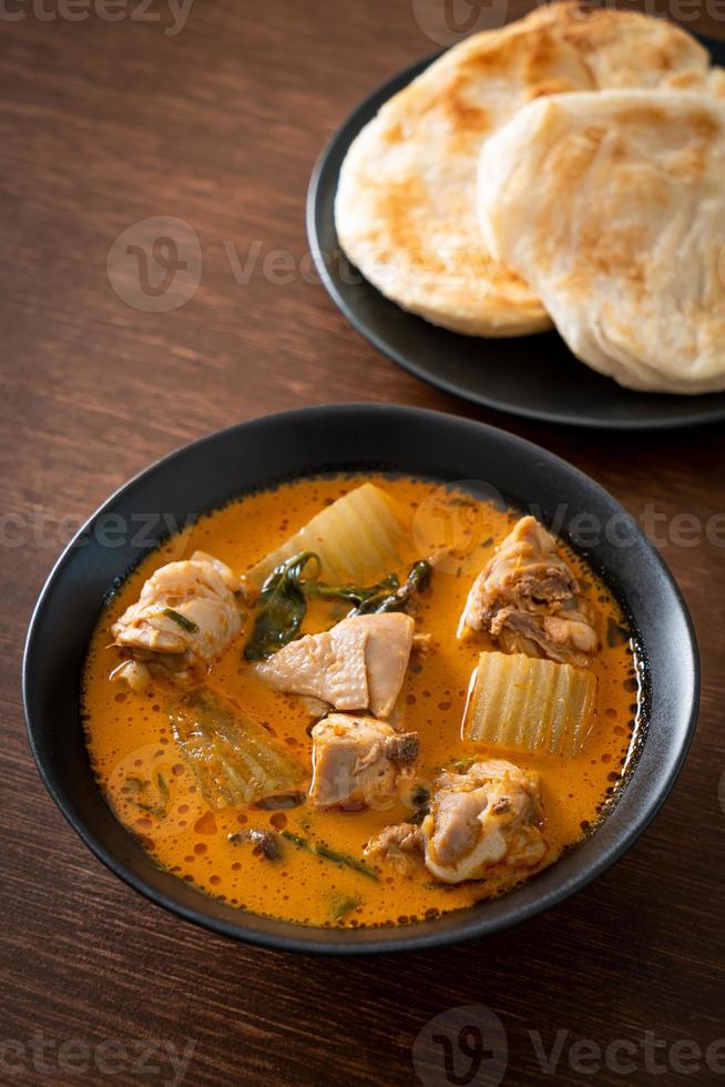 Chicken curry soup with roti photo