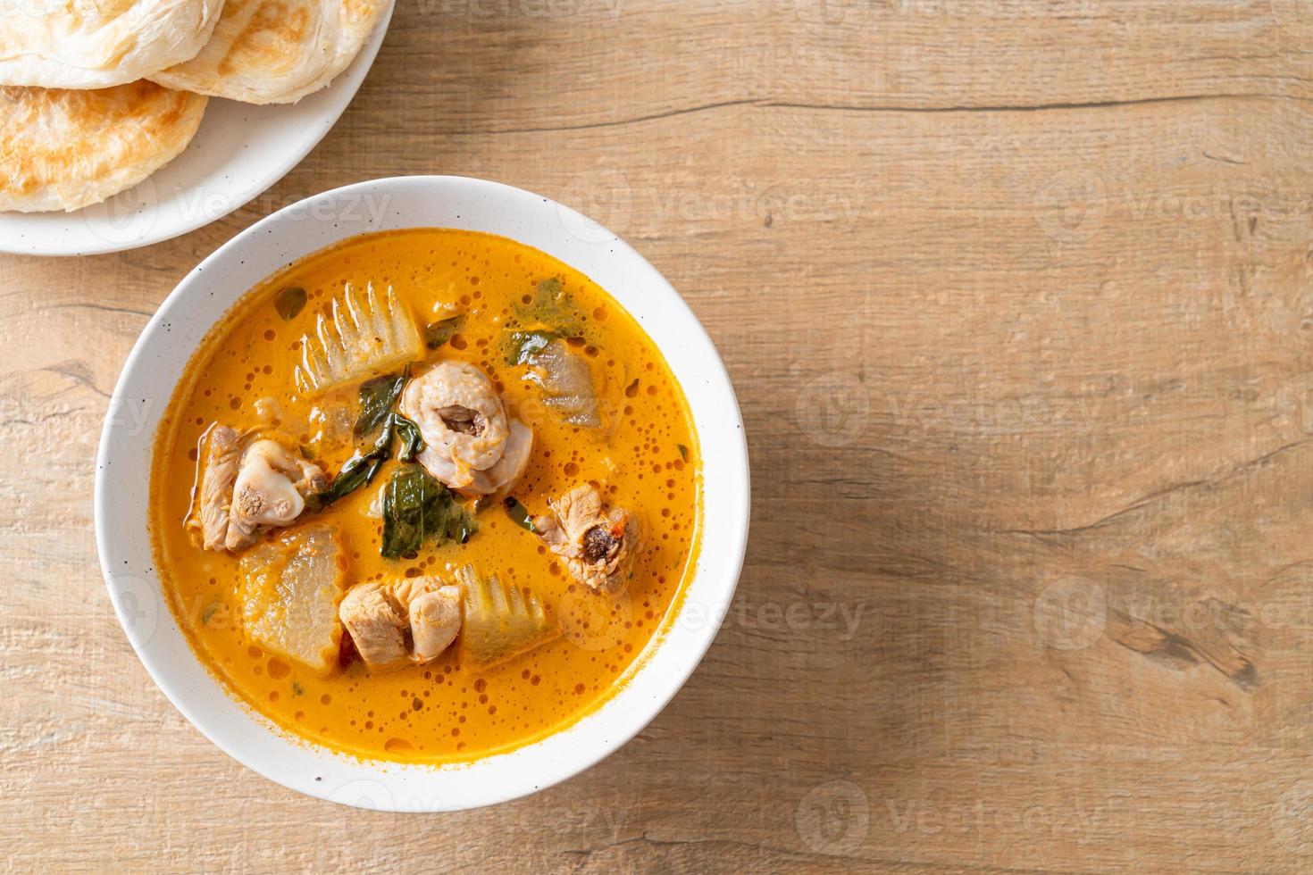 Chicken curry soup with roti photo