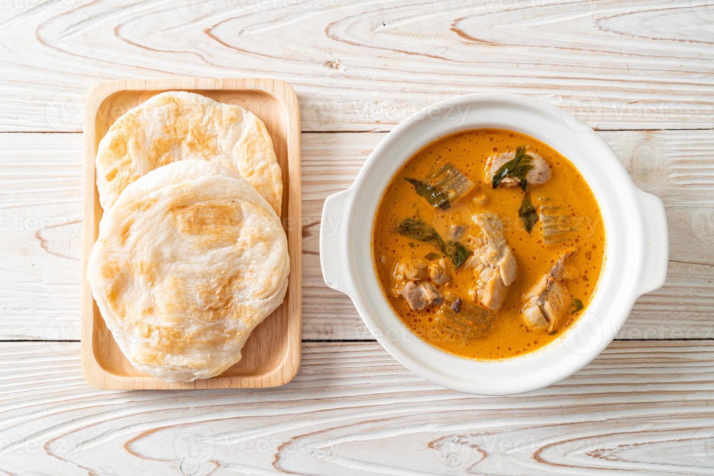 Chicken curry soup with roti photo