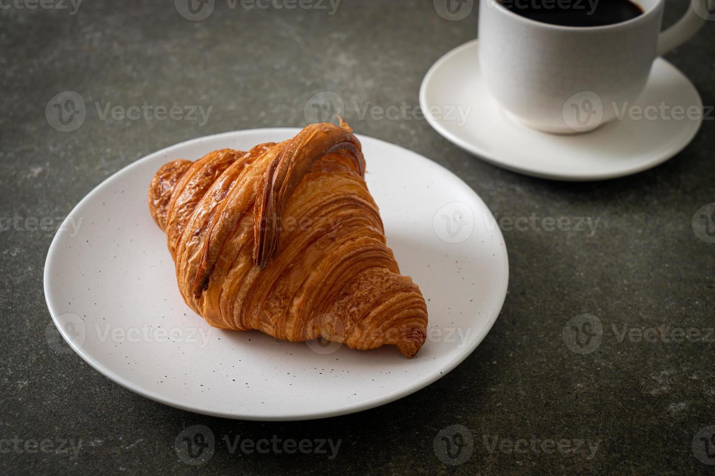 fresh croissant on white plate photo