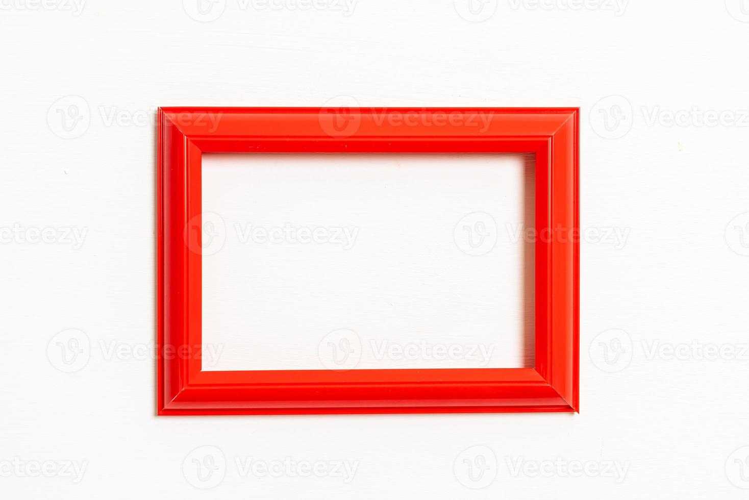 empty picture frame on white wall background photo