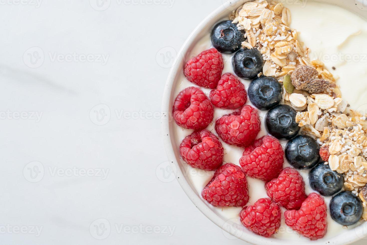 homemade yogurt bowl with raspberry, blueberry and granola photo