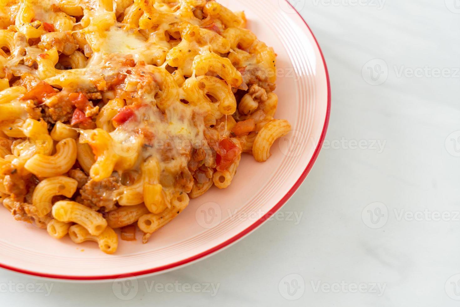 homemade macaroni bolognese with cheese photo