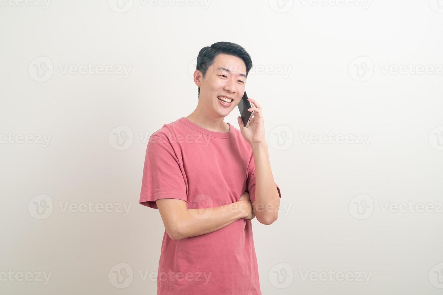 young Asian man using or talking smartphone and mobile phone with happy face photo
