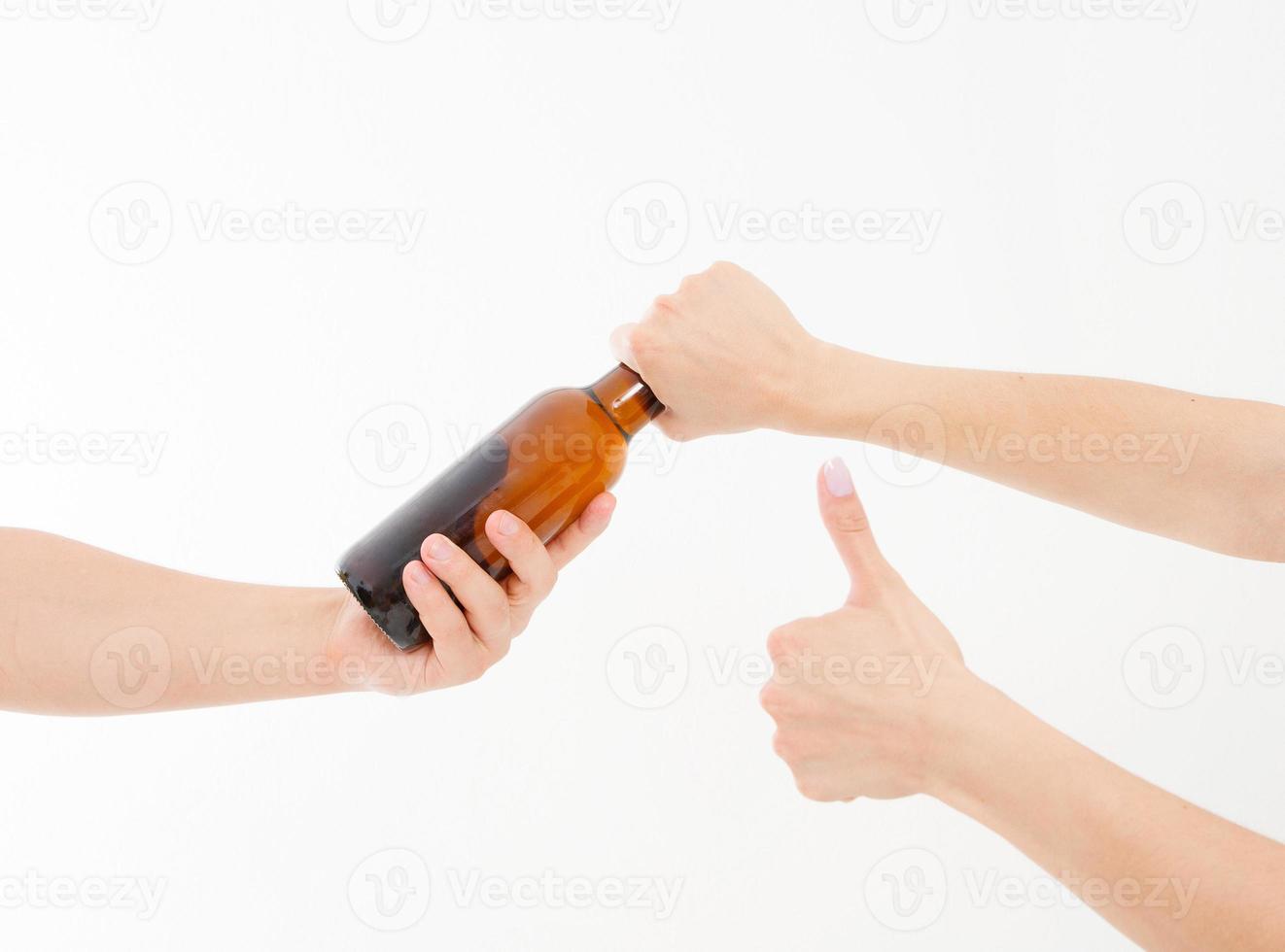 hand takes a beer bottle and shows like isolated on white background. Copy space photo