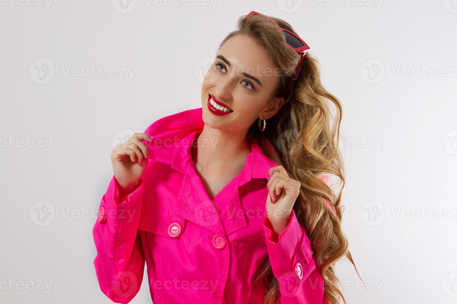 Happy, shock, excited woman face closeup. Girl bright pink autumn clothes, makeup isolated, white background, copy space. Beautiful female surprised, cheerful. Fun funny model smiling, Close-up face photo