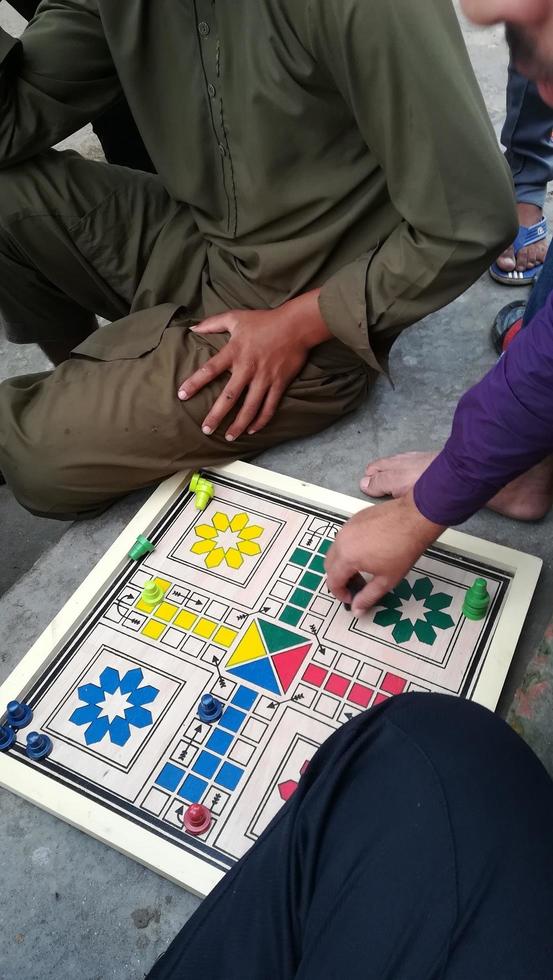 Boys playing a board game together having a lot of fun photo