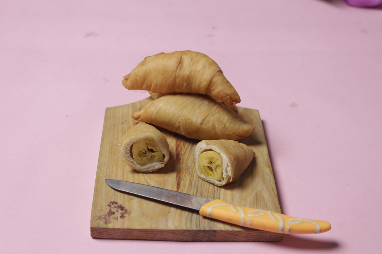 Chocolate bananas from raw materials covered with rolls of pastry dough sheets. Molen bananas with pastries are usually served with a cup of hot coffee or tea. Focus blur photo