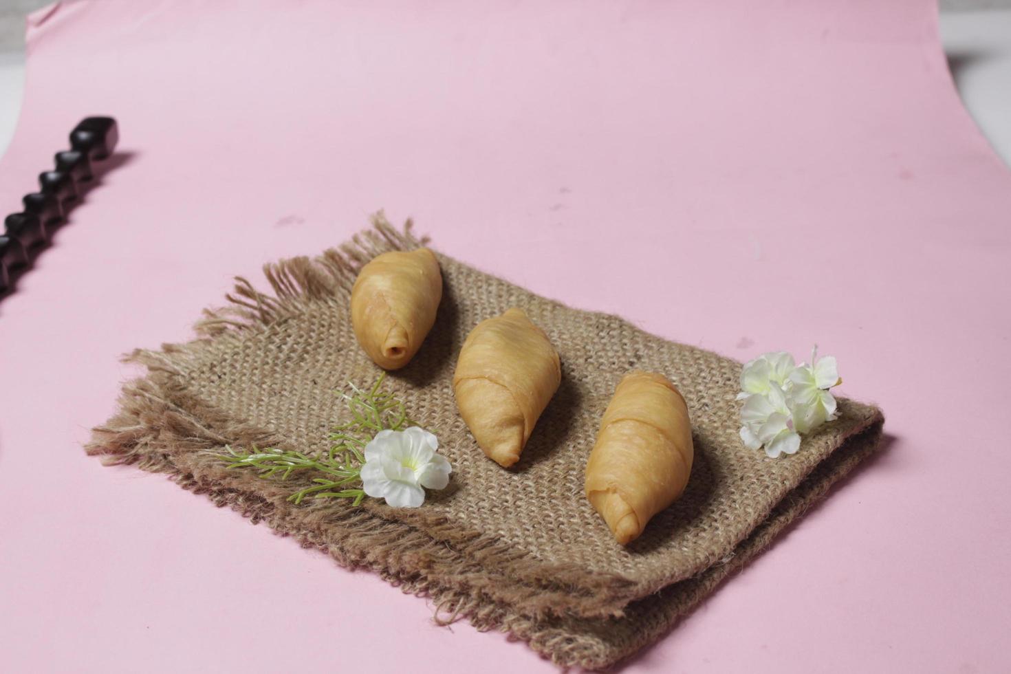 Chocolate bananas from raw materials covered with rolls of pastry dough sheets. Molen bananas with pastries are usually served with a cup of hot coffee or tea. Focus blur photo