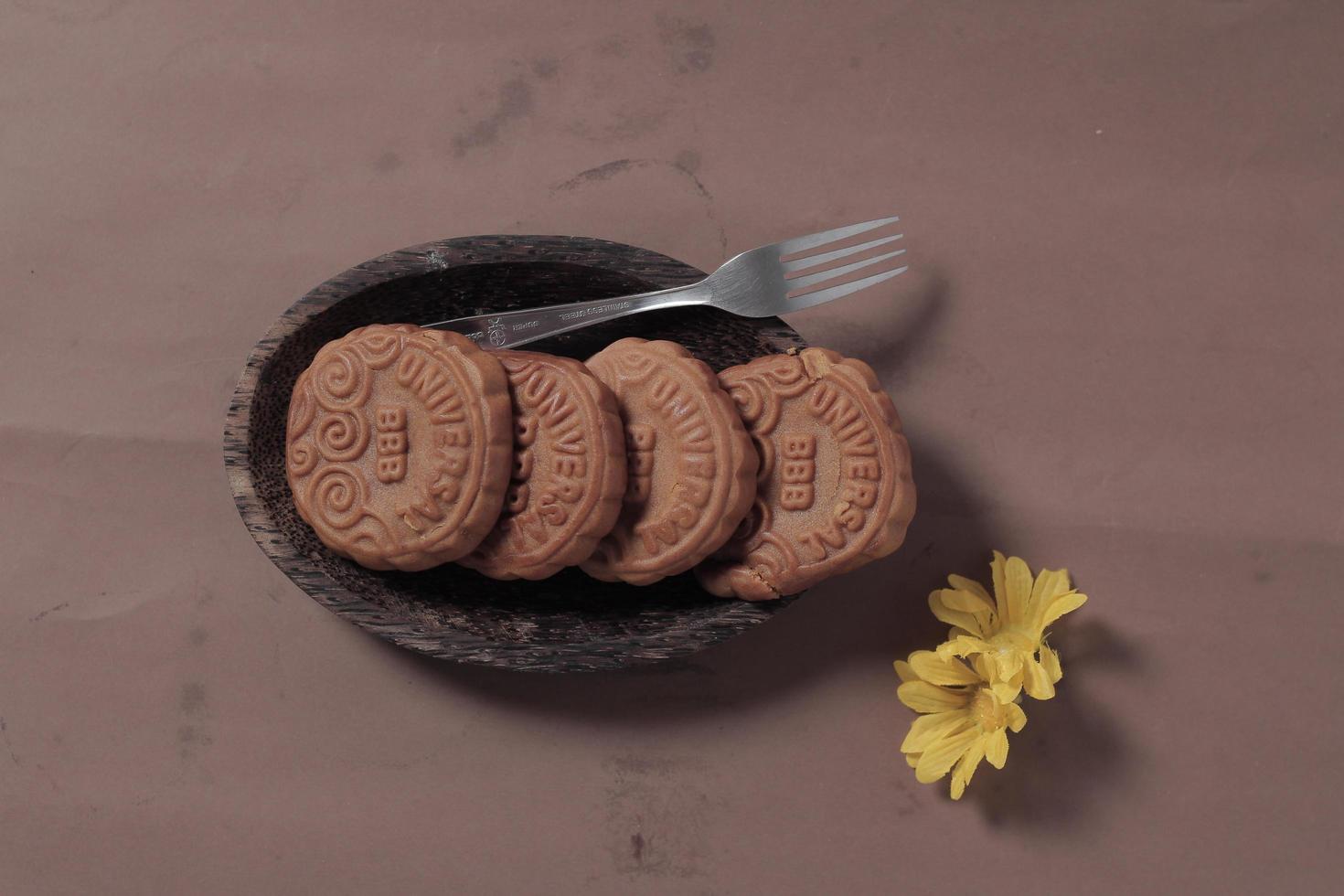 Square-shaped chocolate biscuits are suitable as a side snack to the breakfast menu. Start the morning with biscuits. Can be consumed by all ages from toddlers to the elderly. Stack of biscuits. photo